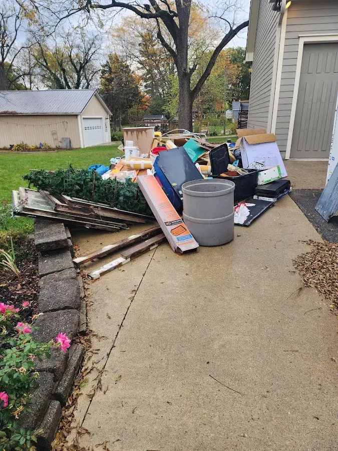 Dumpster being loaded with debris for 10 Yard Dumpster Rental in Plainwell